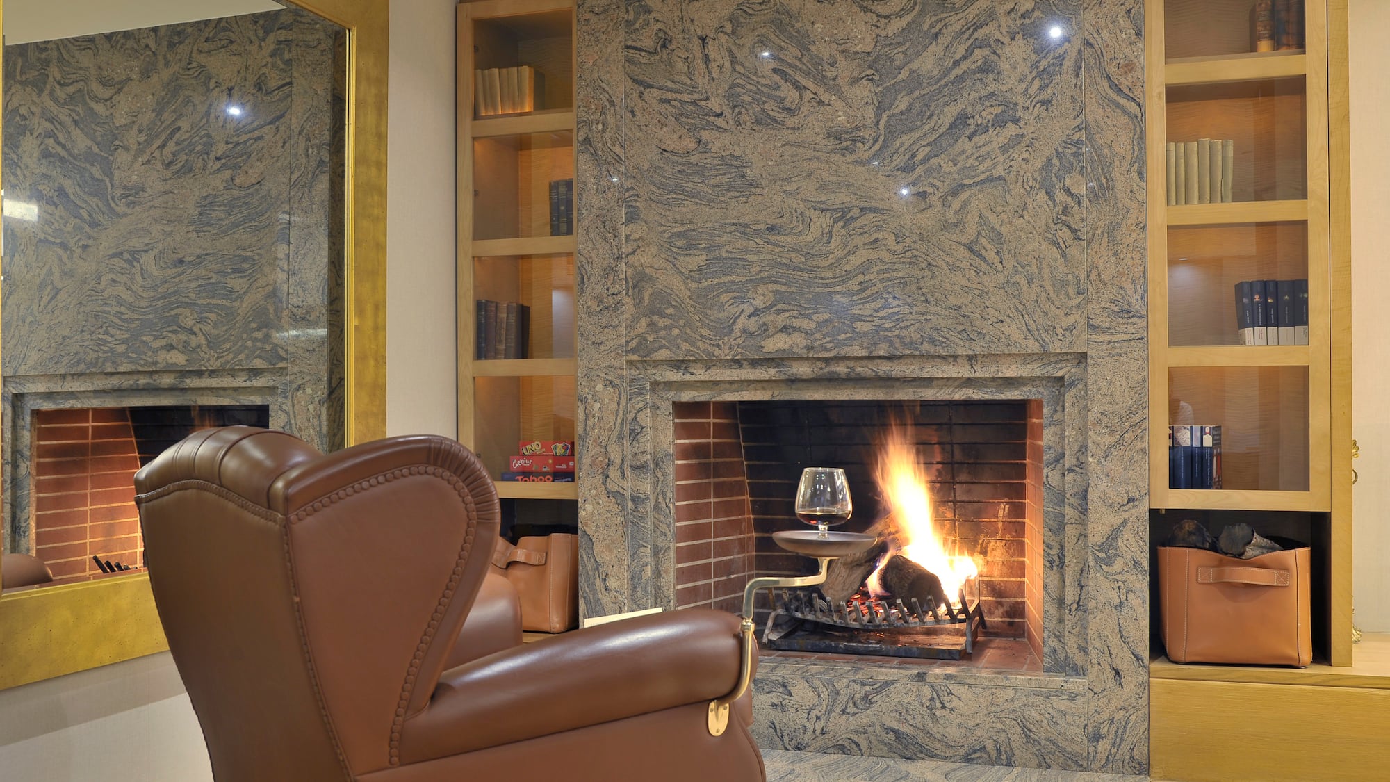 a fireplace with a glass of wine in it