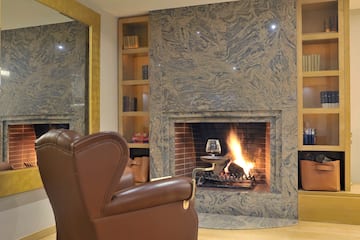 a fireplace with a glass of wine in it