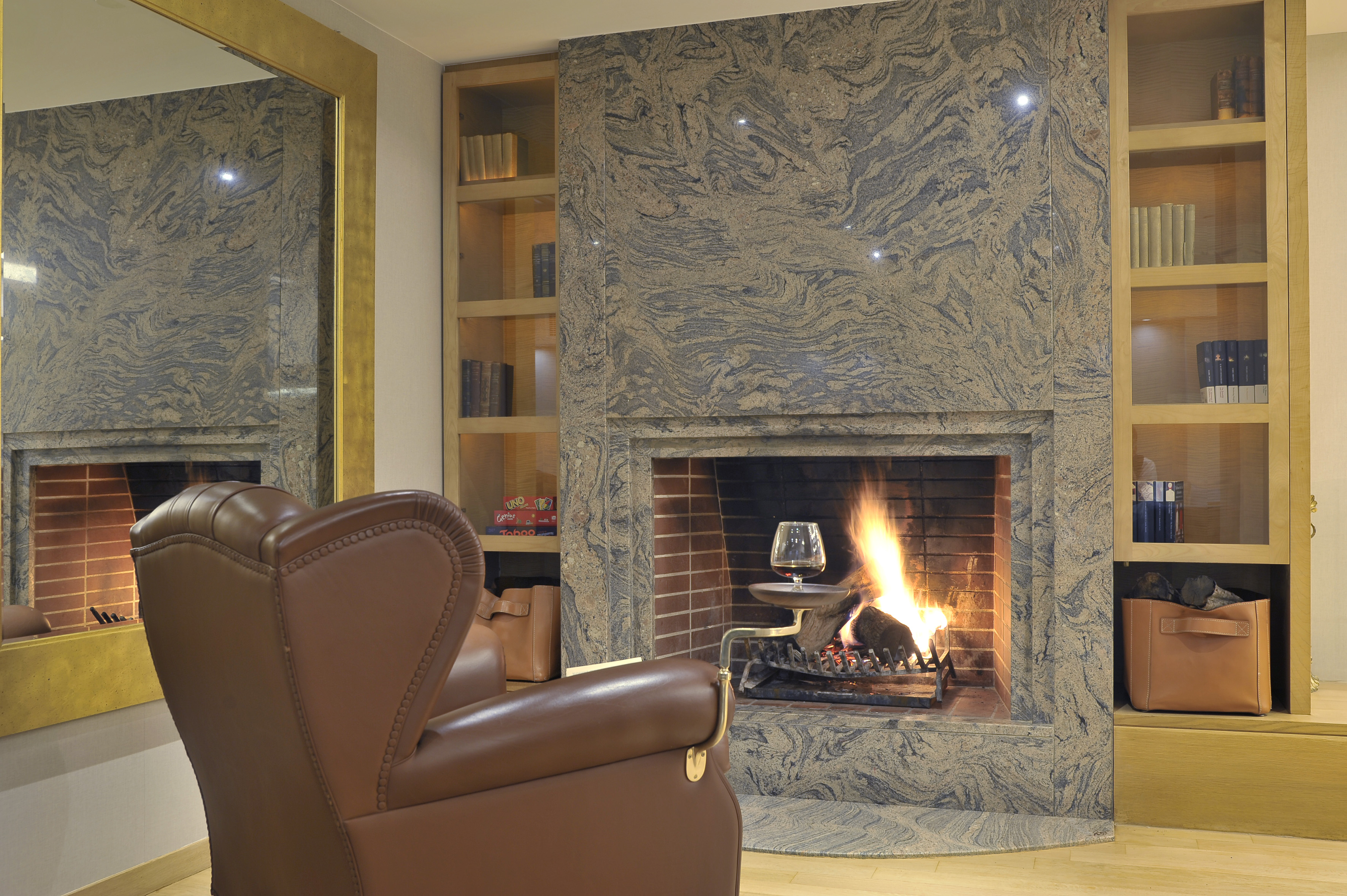 a fireplace with a glass of wine in it