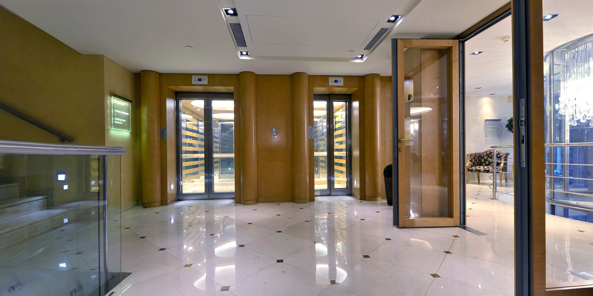 a lobby with glass doors and a marble floor