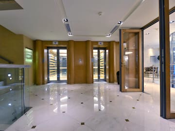 a lobby with glass doors and a marble floor