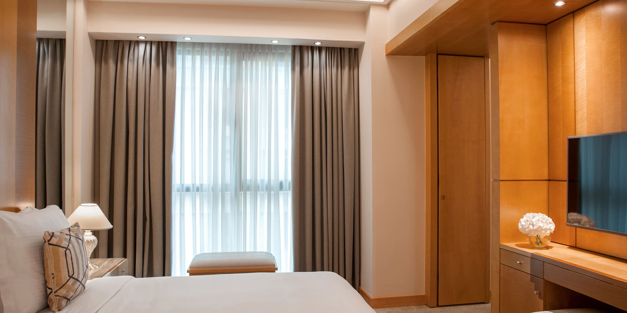 a bedroom with a bed and a desk