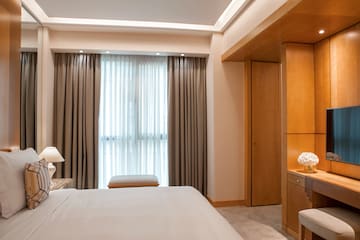 a bedroom with a bed and a desk