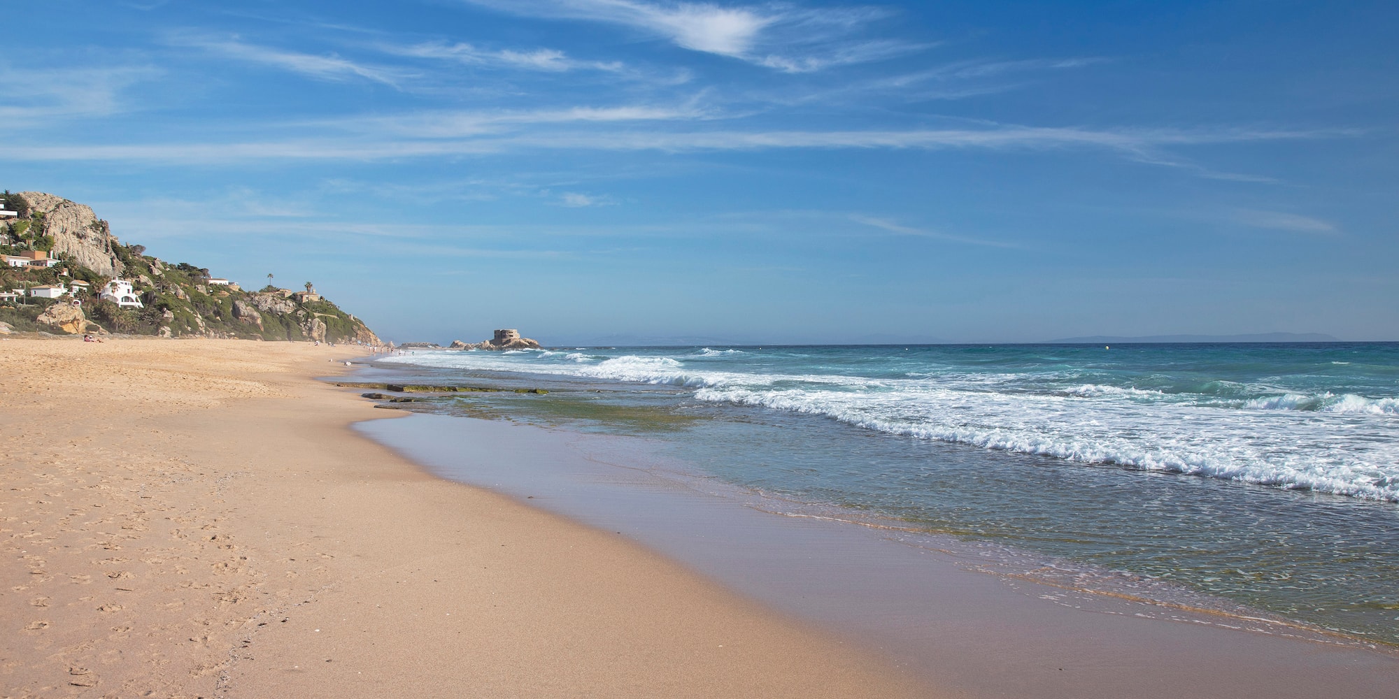 a beach with waves crashing on the shore