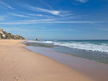 a beach with waves crashing on the shore