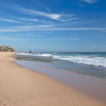 a beach with waves crashing on the shore