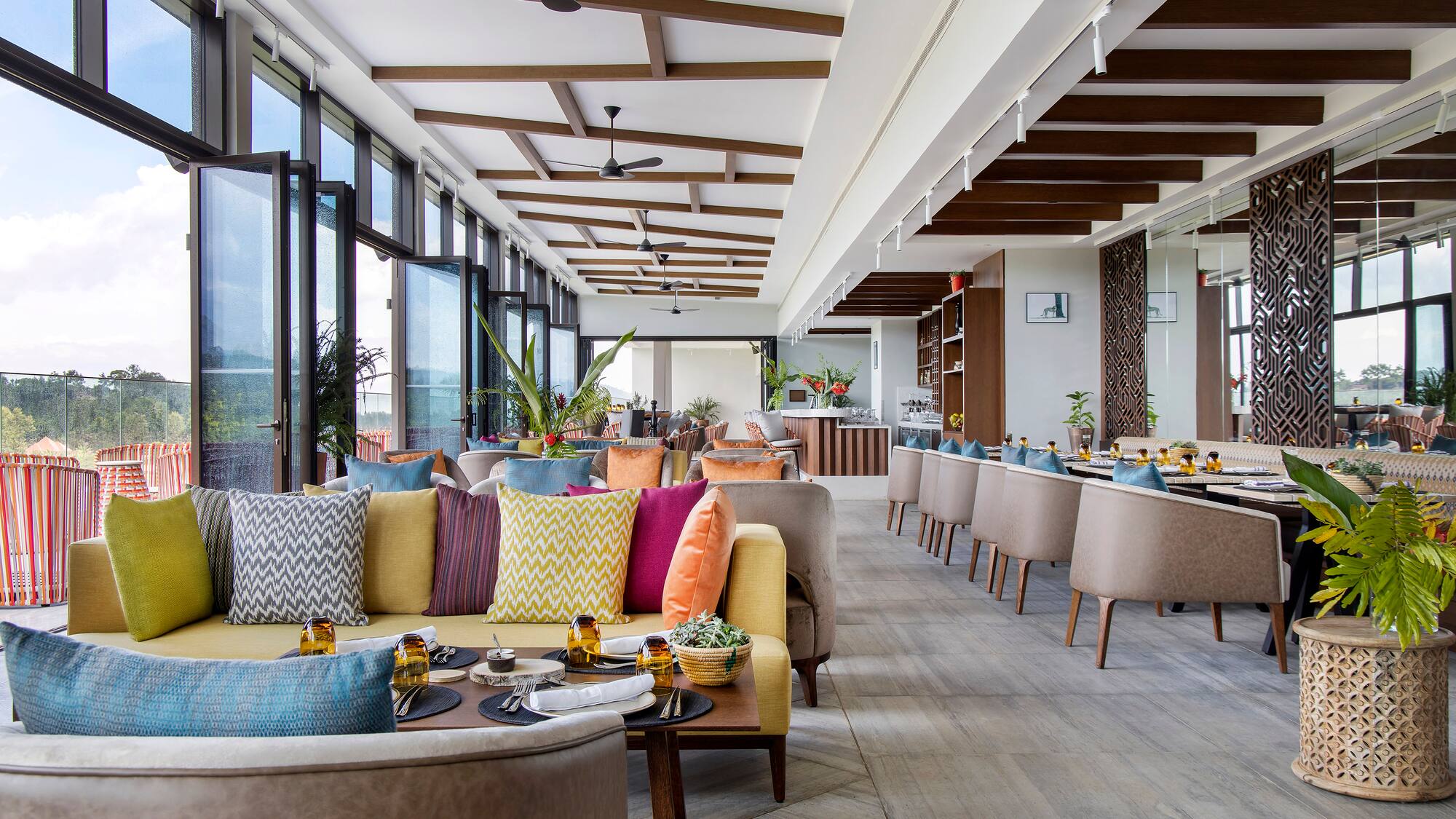 a room with couches and tables and chairs