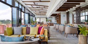 a room with couches and tables and chairs