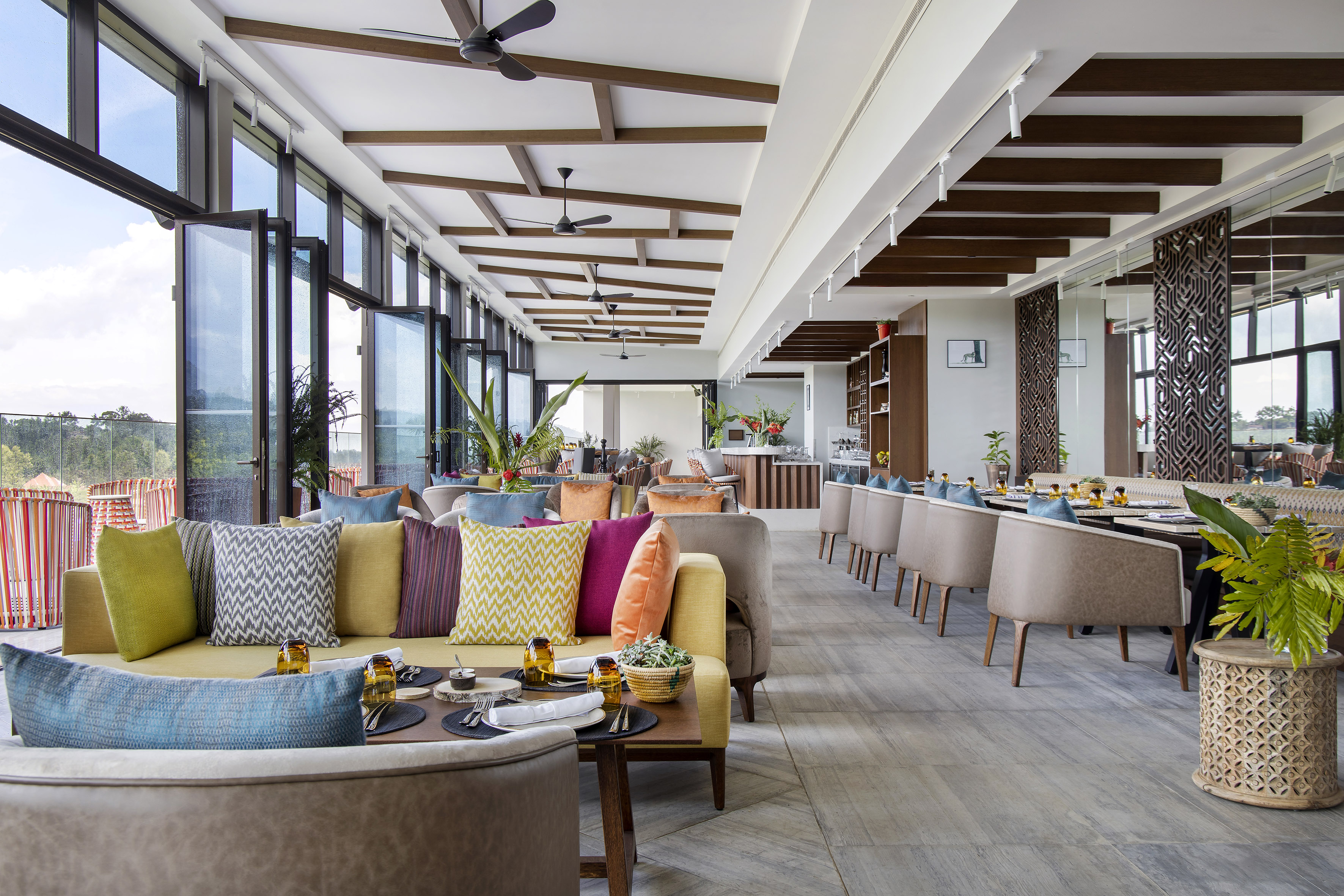 Spacious modern restaurant with stylish seating, outdoor view, and large windows.
