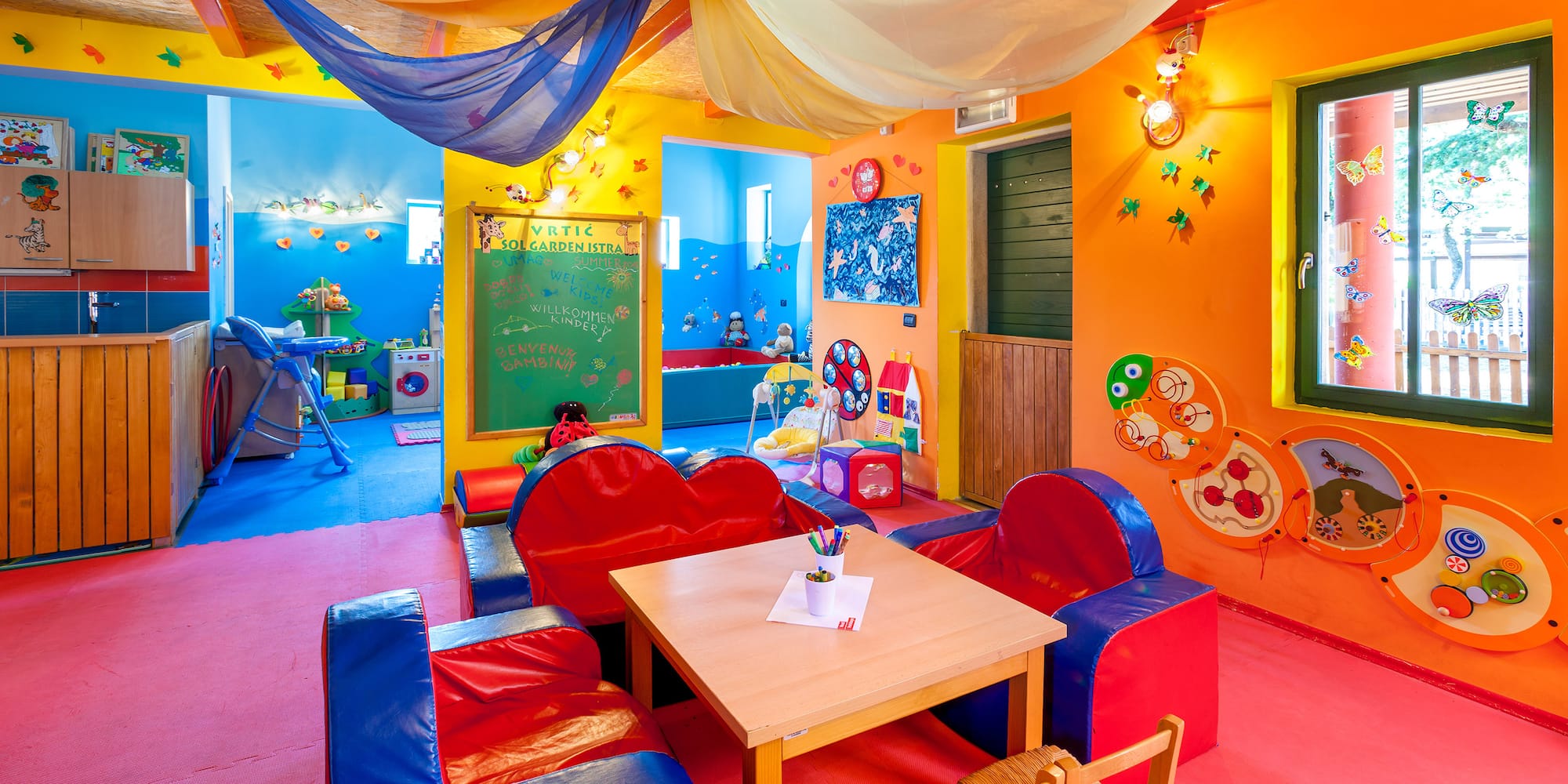 a room with colorful walls and a table and chairs