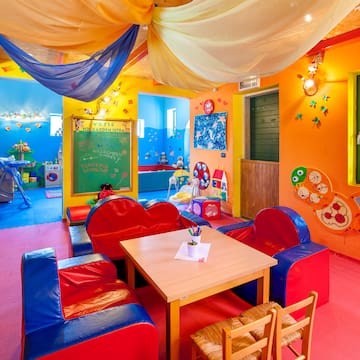 a room with colorful walls and a table and chairs