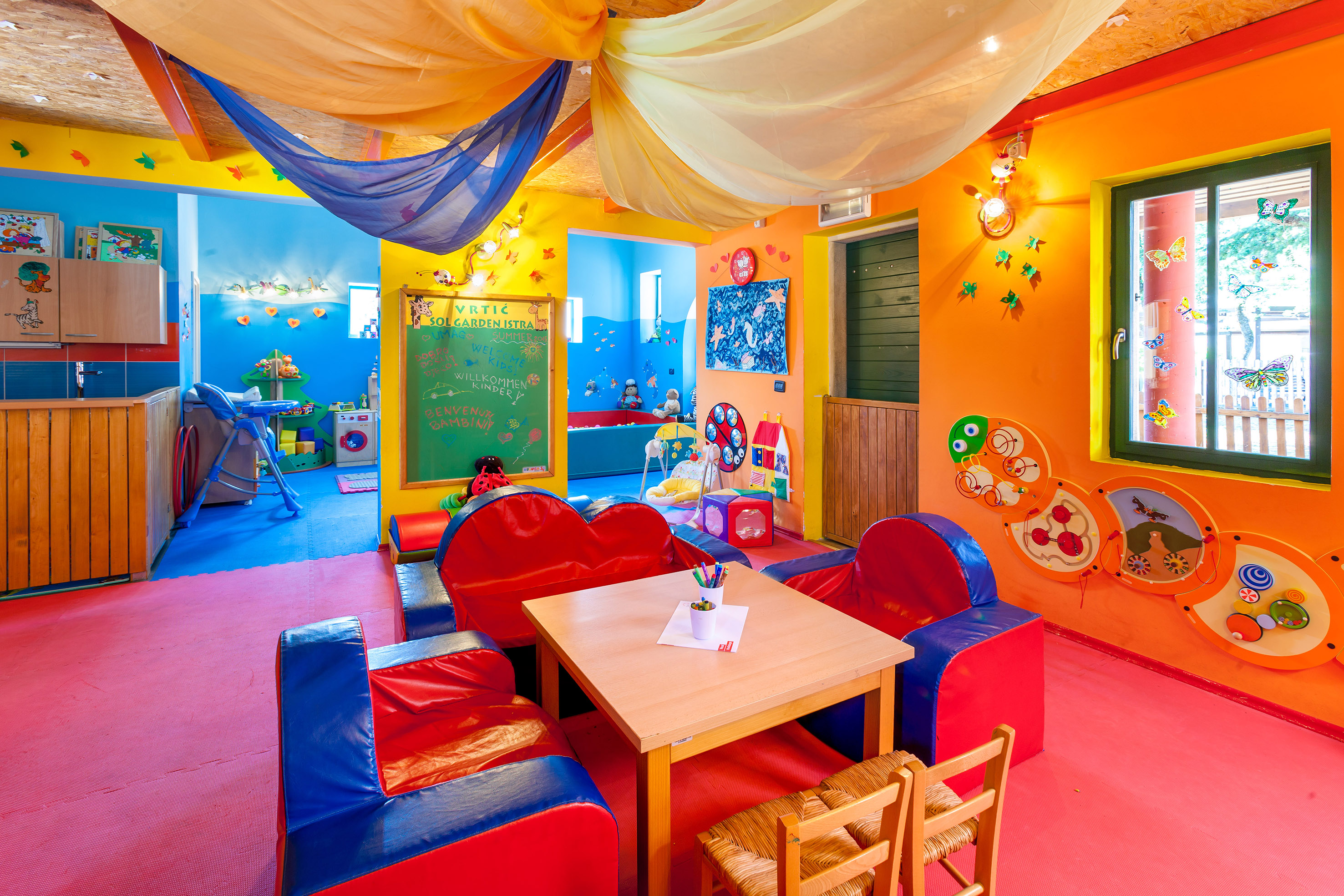 a room with colorful walls and a table and chairs