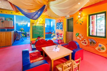 a room with colorful walls and a table and chairs