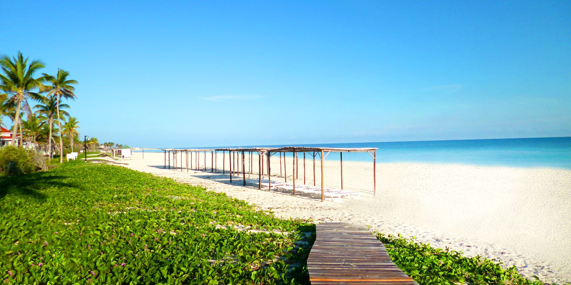 a wooden walkway leading to a beach