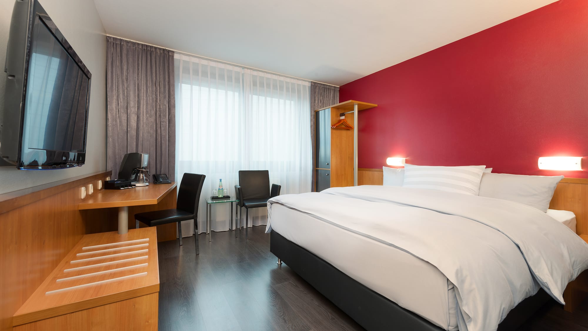 a room with a bed and desk and chair