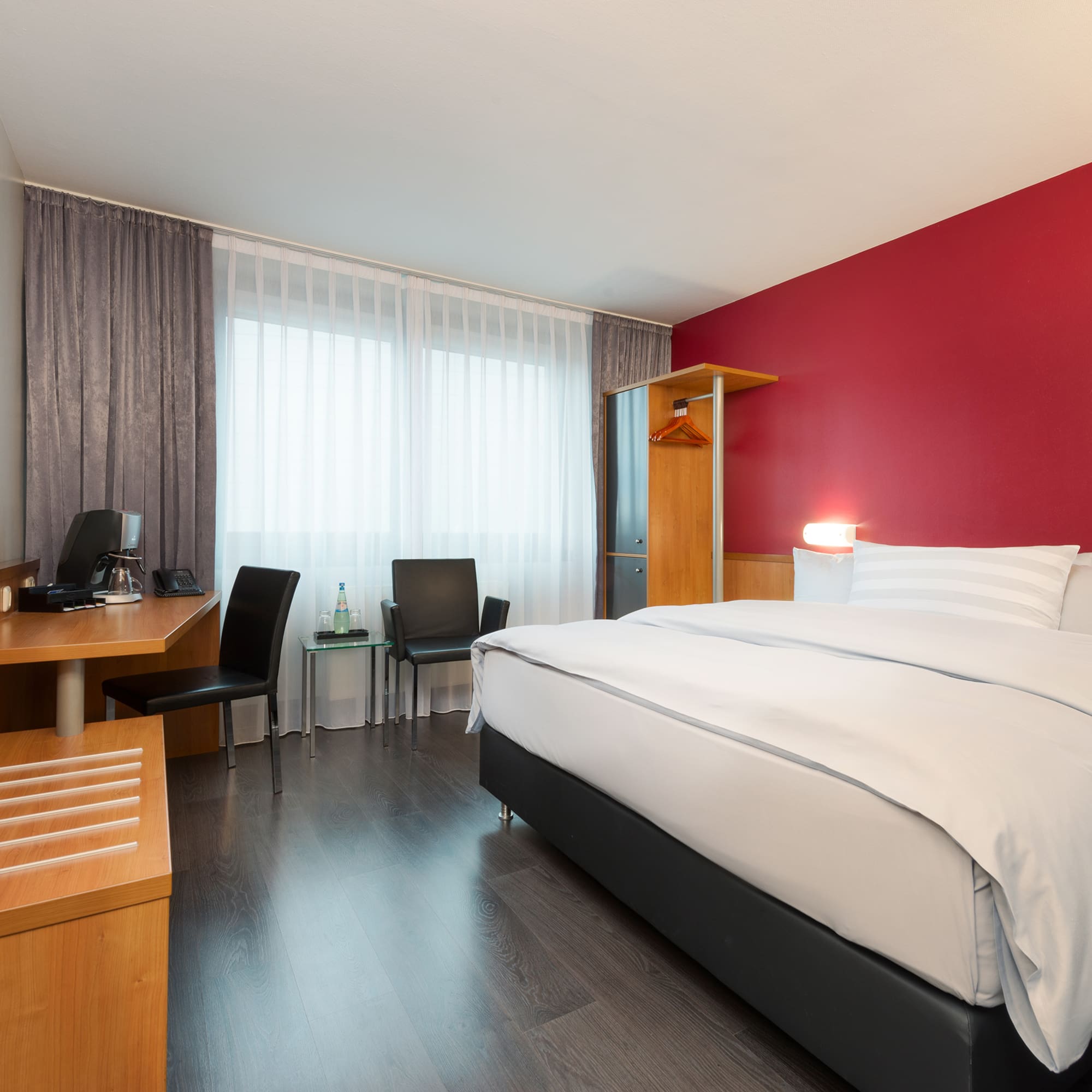 a room with a bed and desk and chair