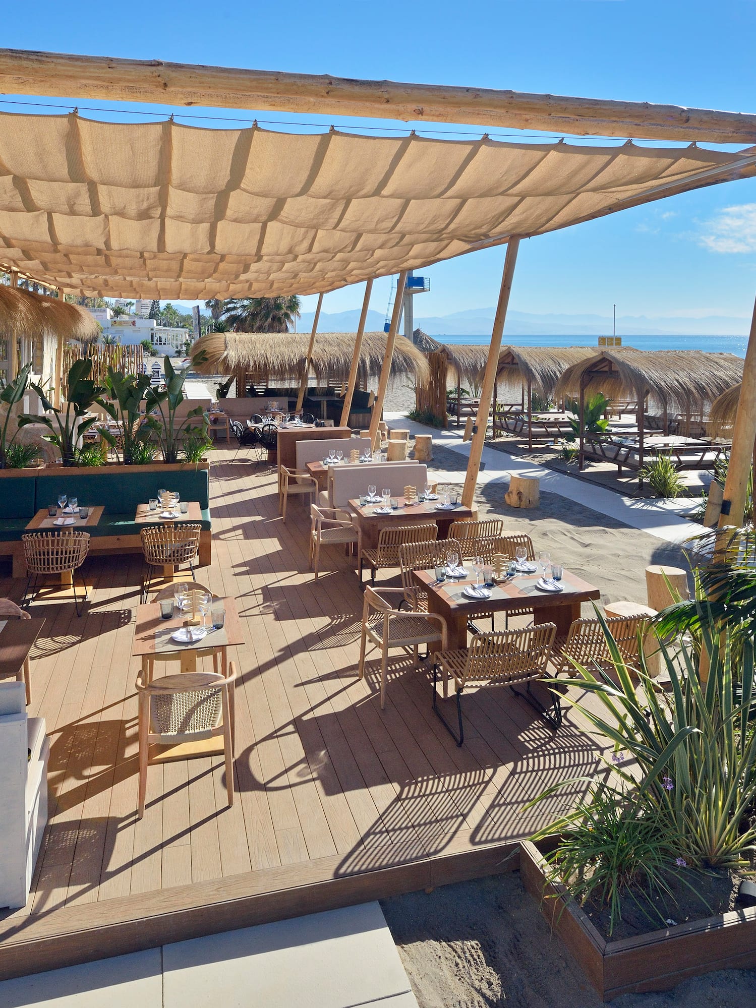 a restaurant with tables and chairs on a beach