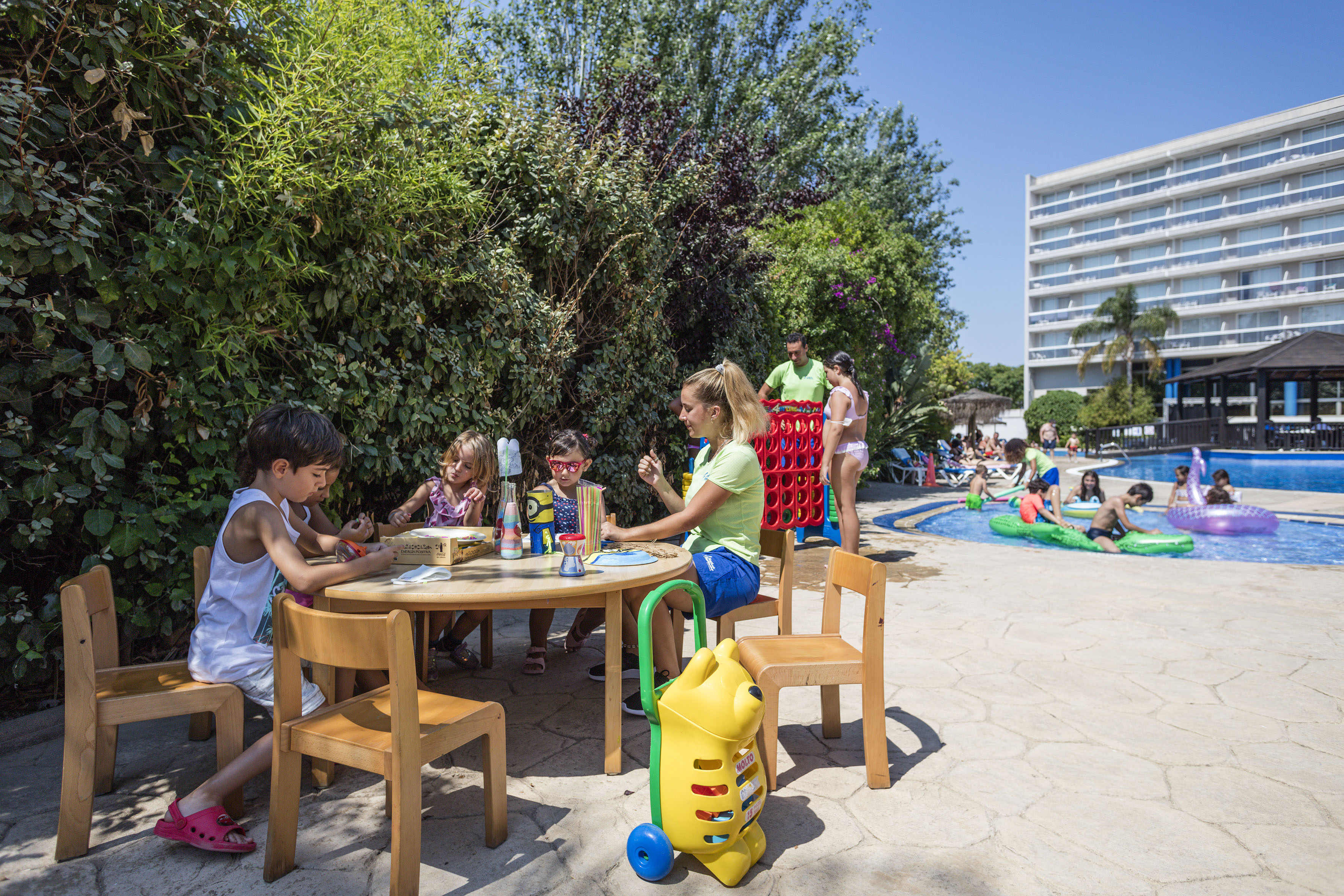 a group of kids sitting around a table outside