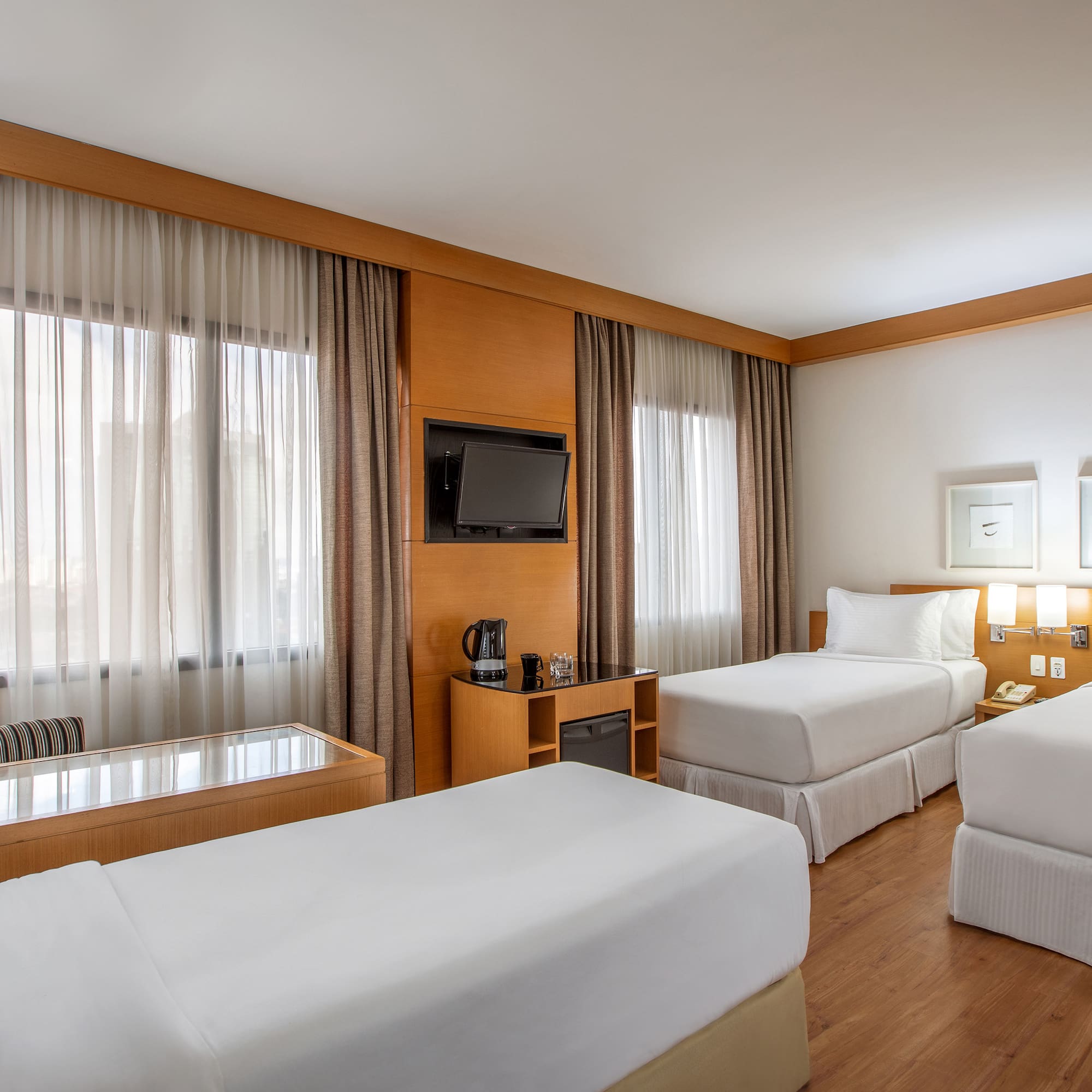 a room with two beds and a television