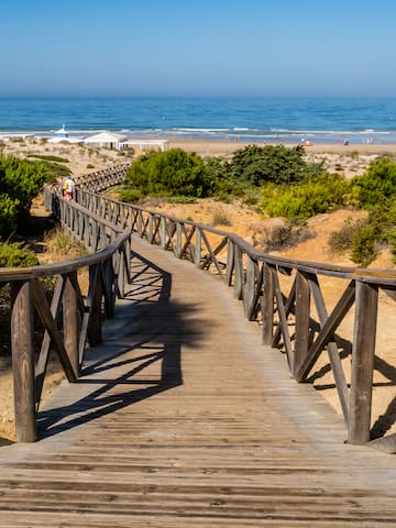 a wooden walkway leading to a beach