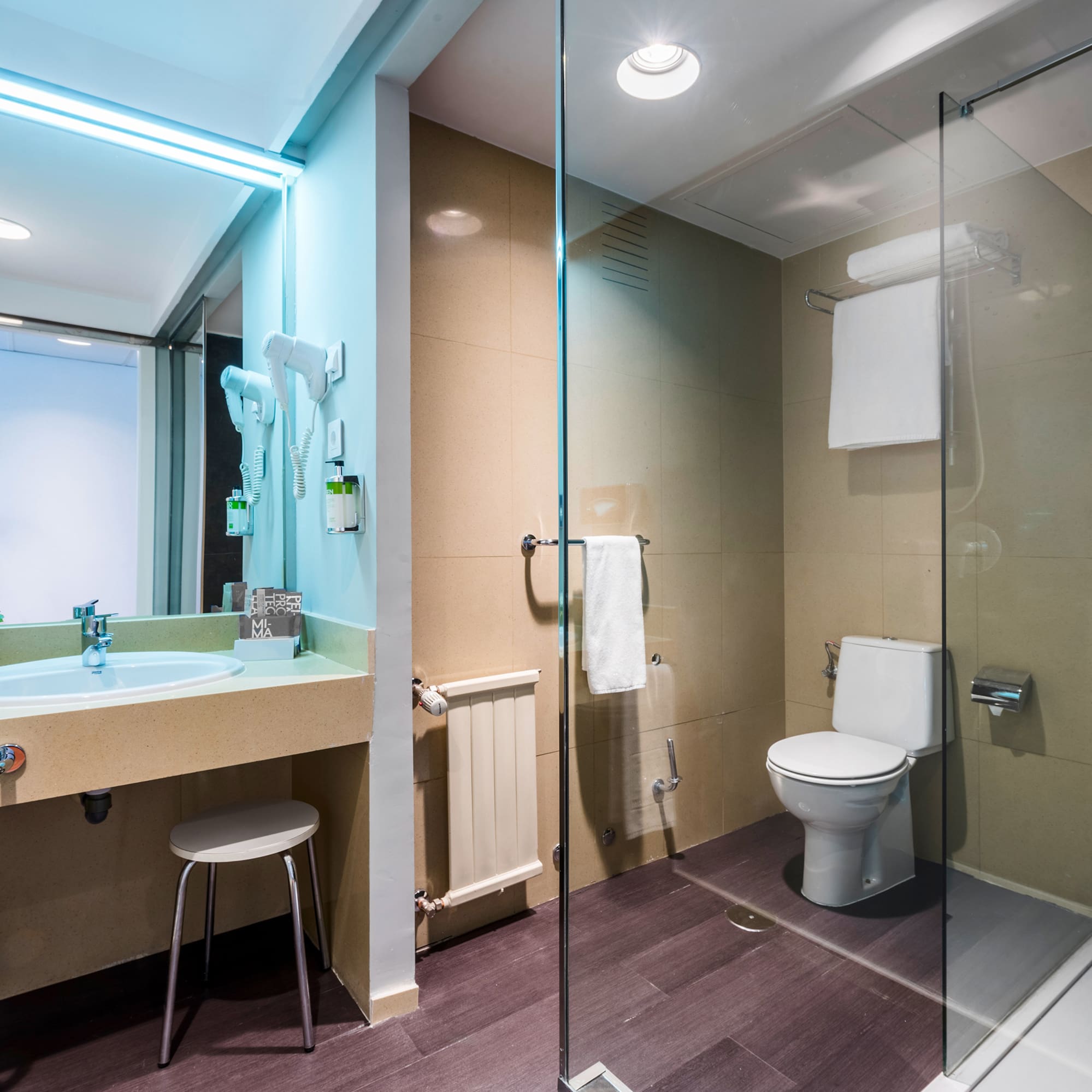 a bathroom with a glass shower and toilet