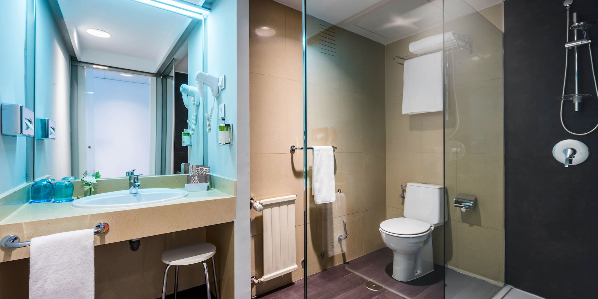 a bathroom with a glass shower and toilet