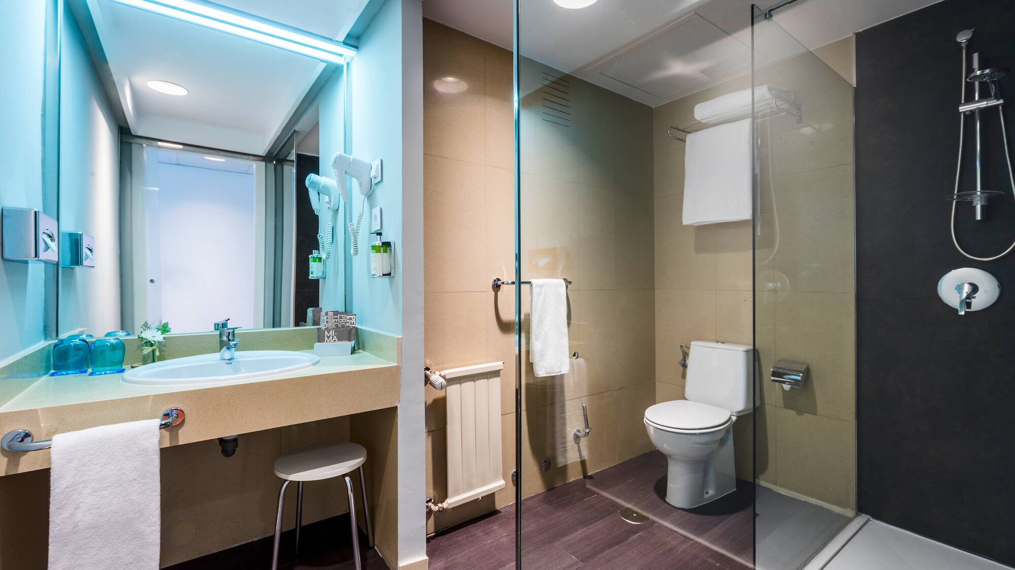 a bathroom with a glass shower and toilet