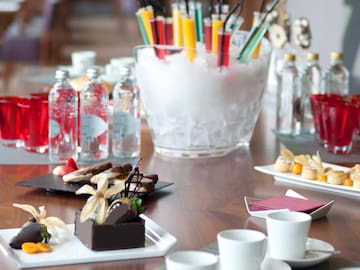 a table with drinks and desserts
