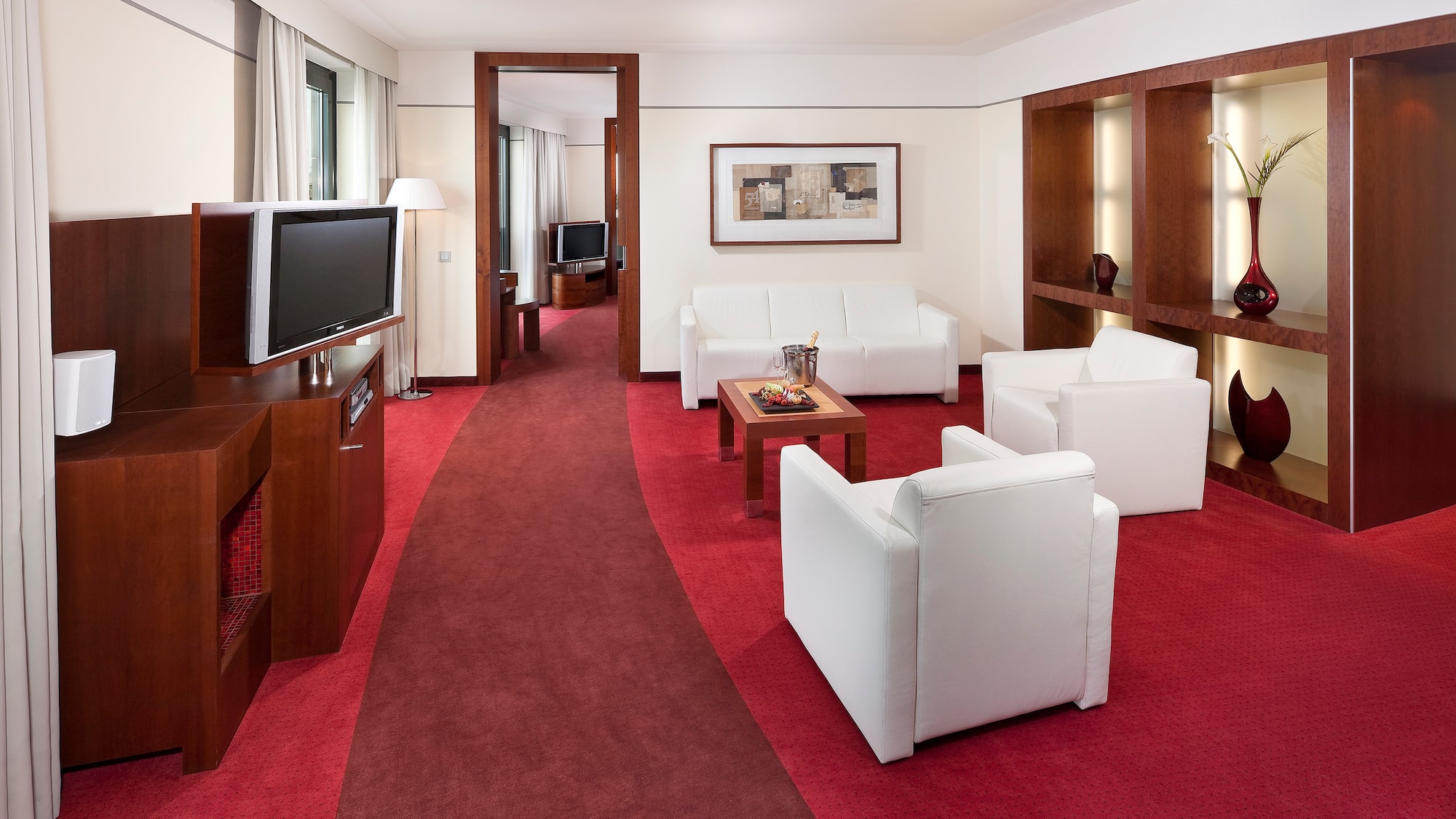 a room with white furniture and red carpet