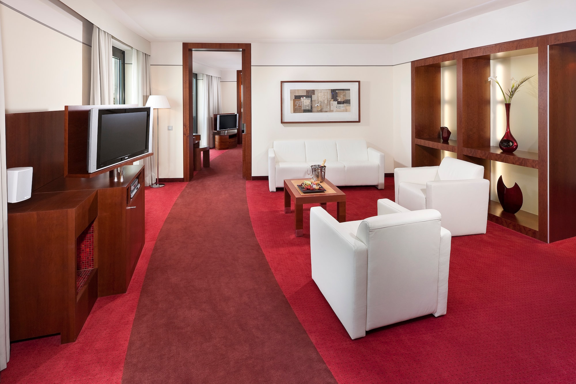 a room with white furniture and red carpet