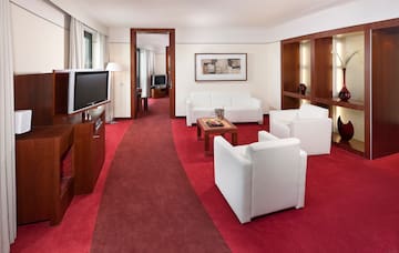 a room with white furniture and red carpet