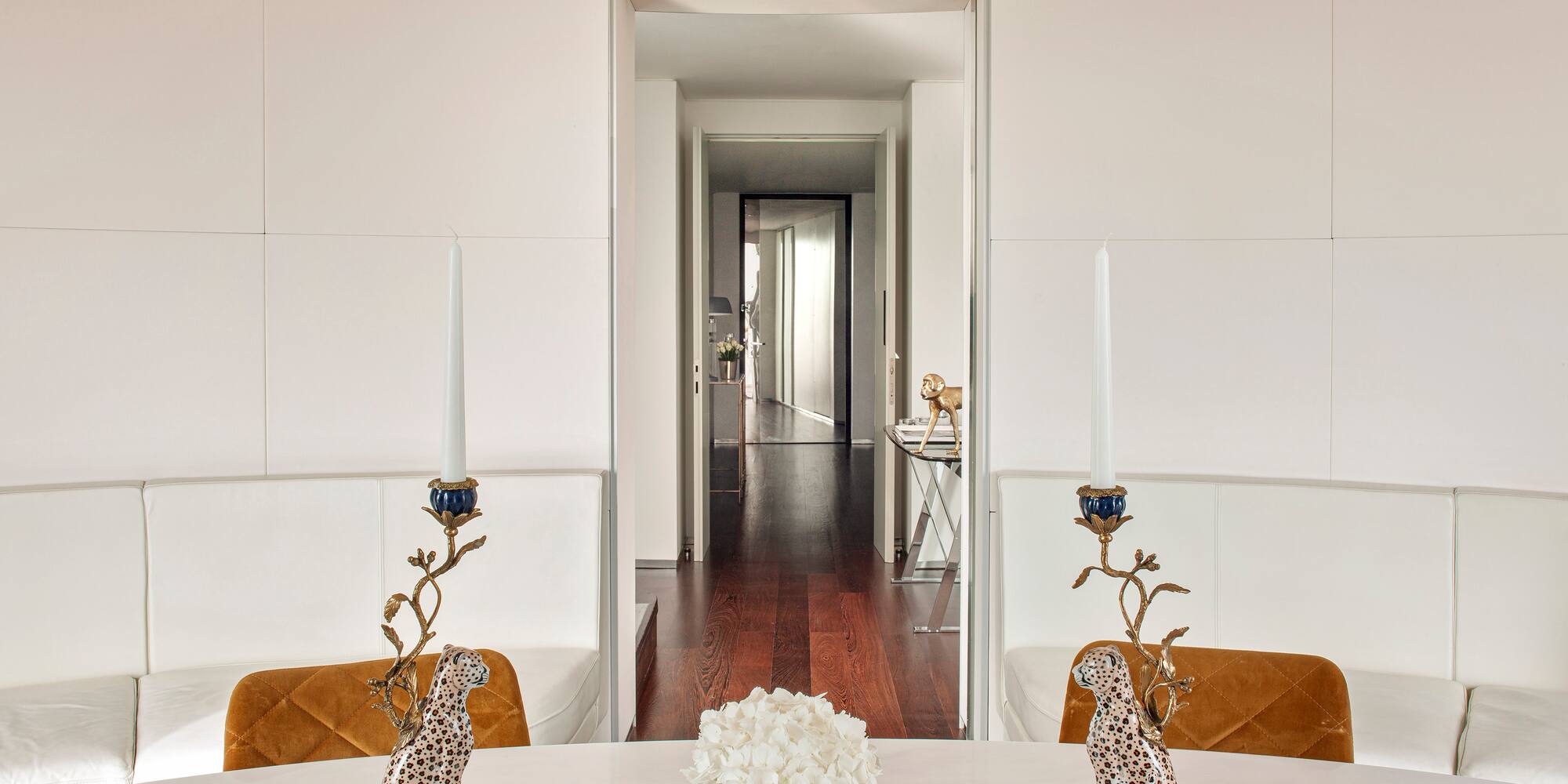 a table with candles and a vase of flowers