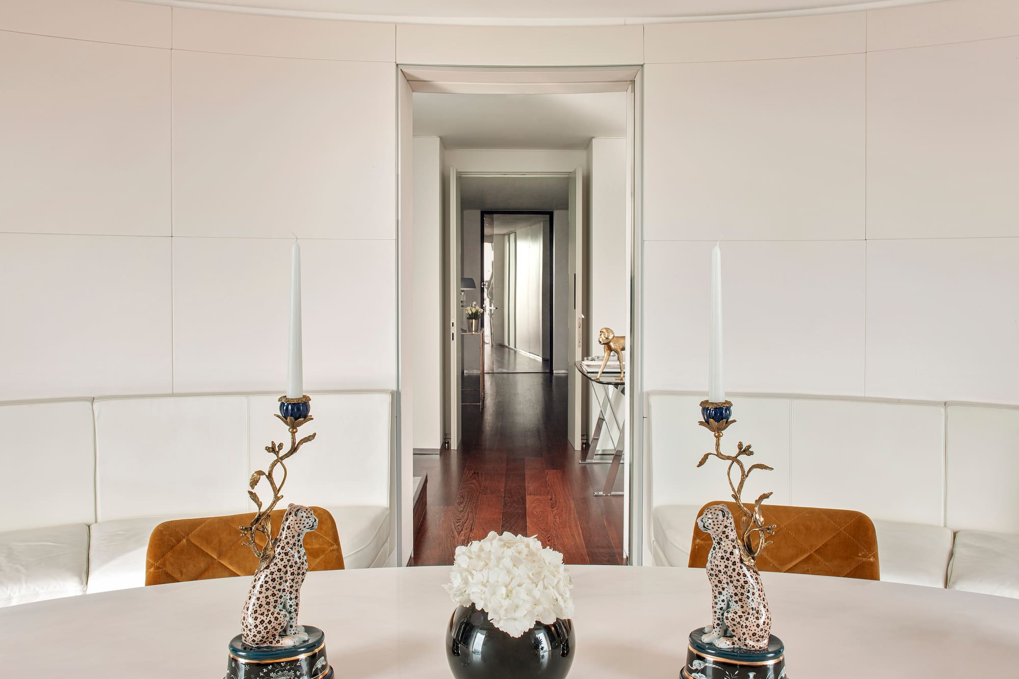 a table with candles and a vase of flowers