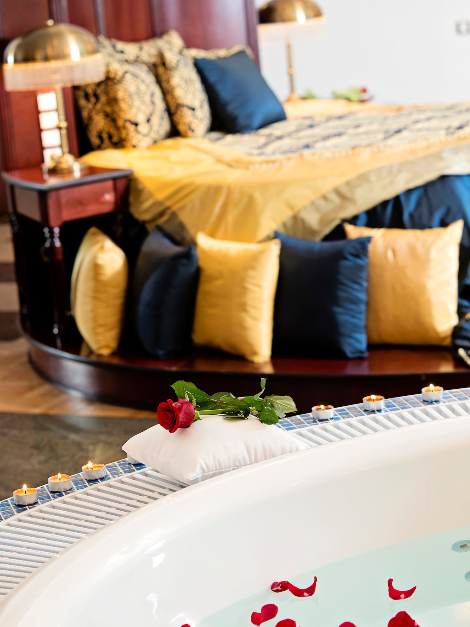 a rose on a pillow on a bathtub