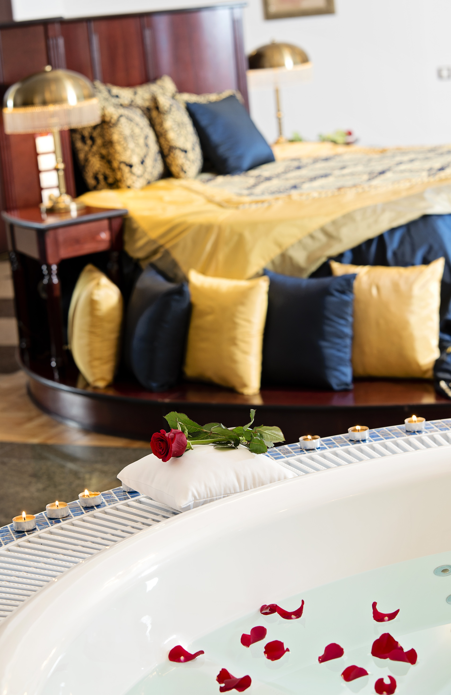 a rose on a pillow on a bathtub