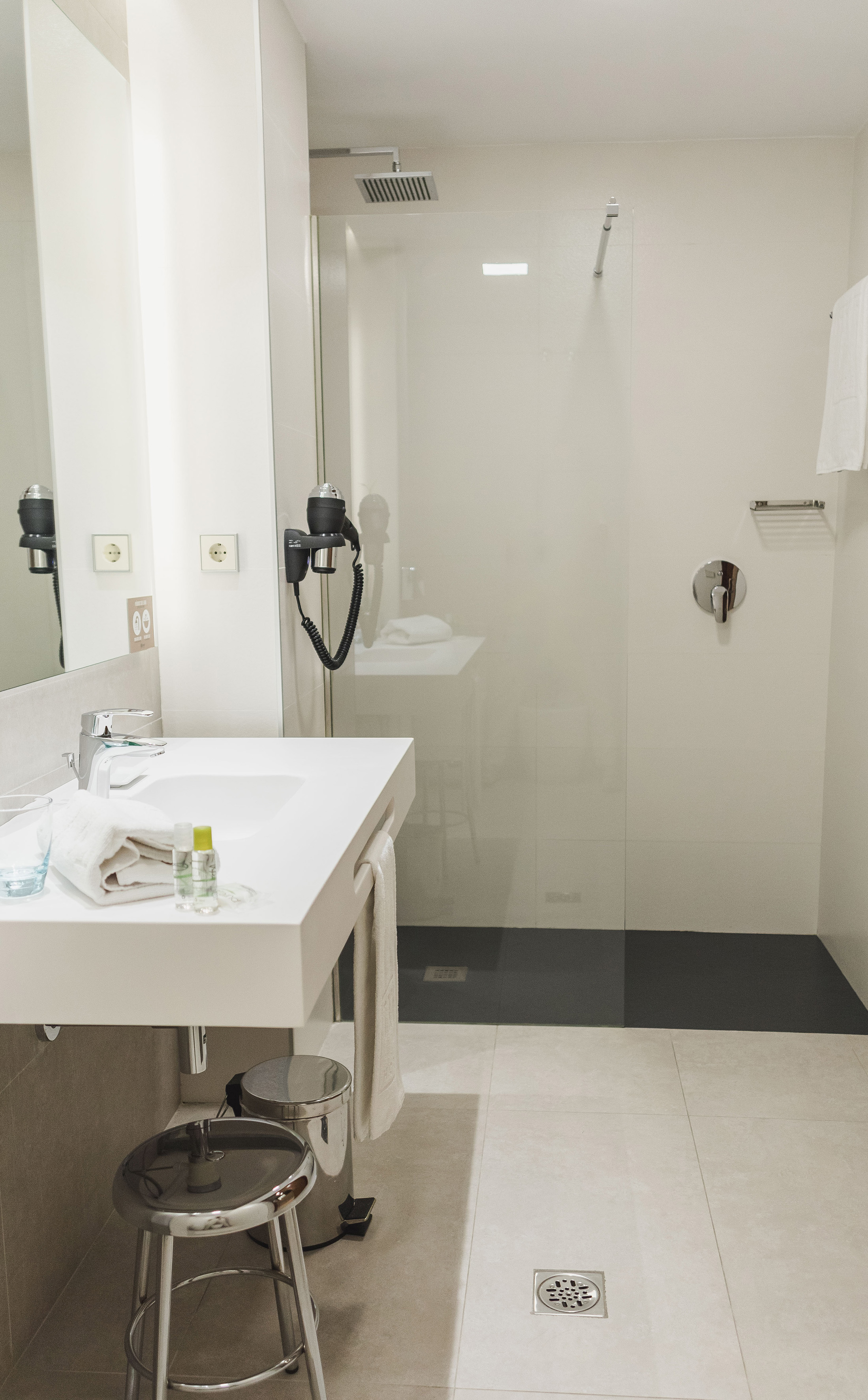 a bathroom with a shower and sink