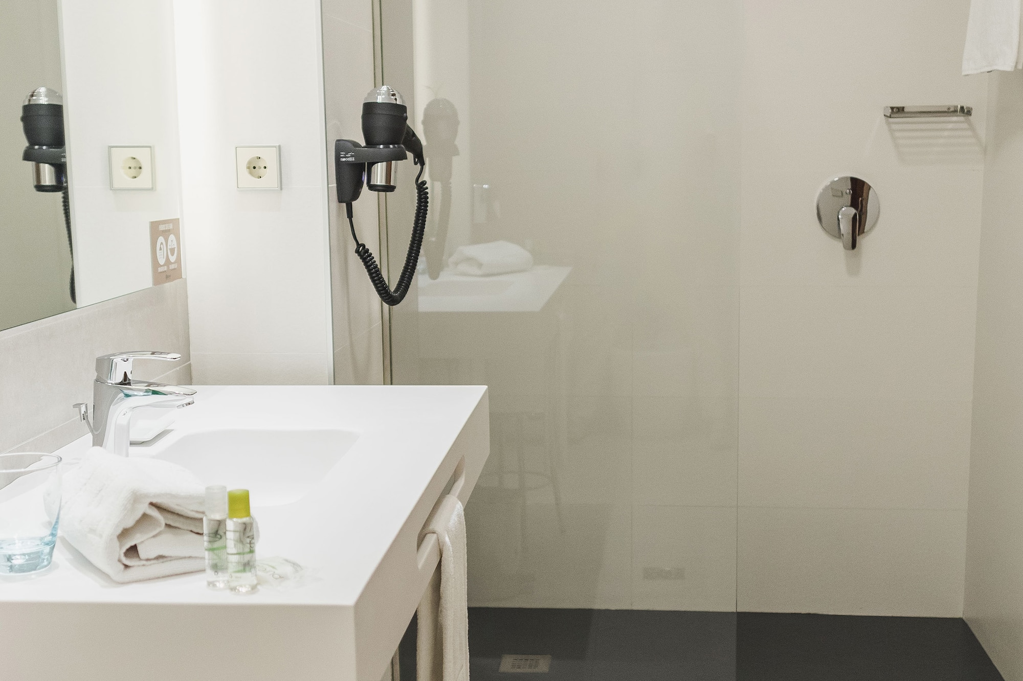 a bathroom with a shower and sink