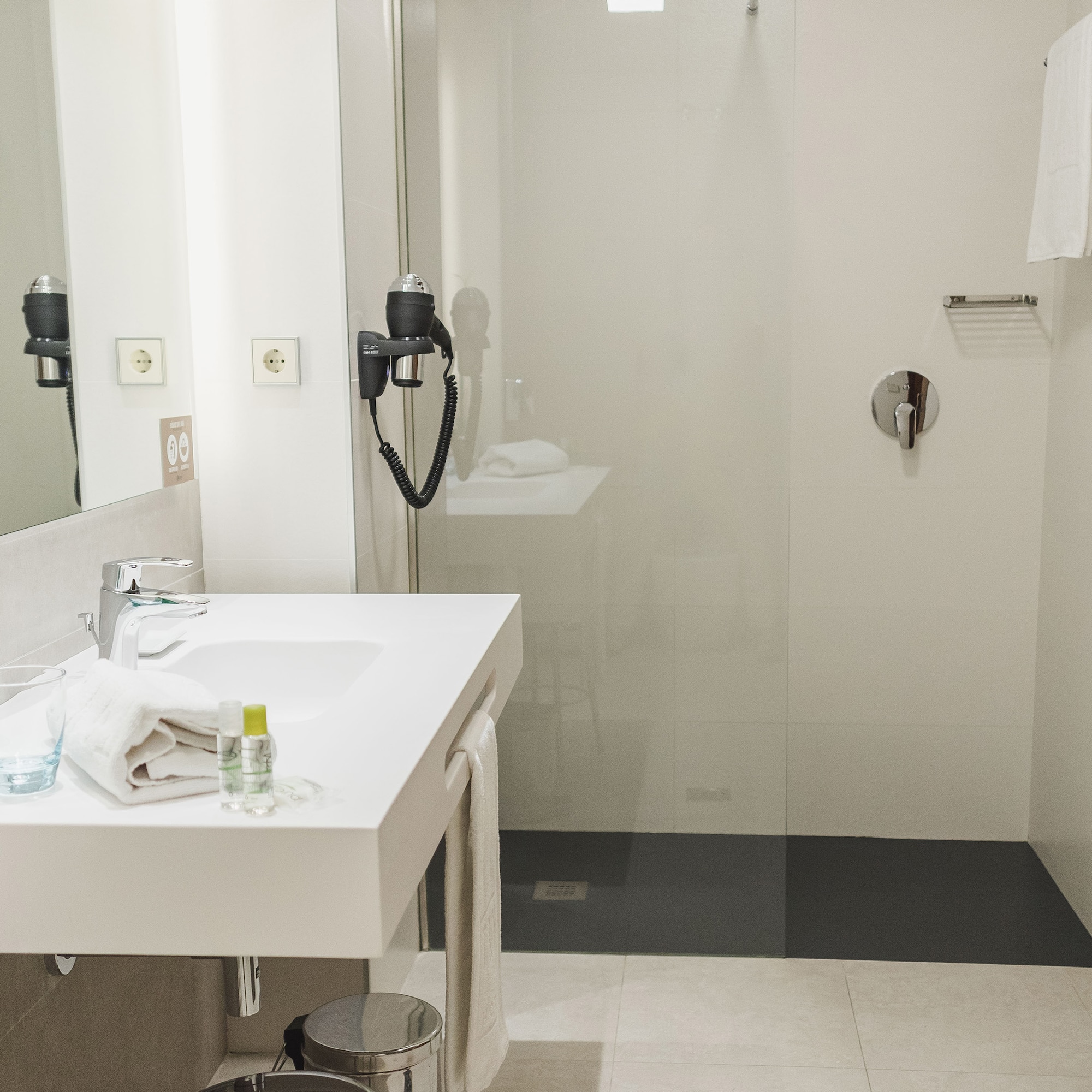 a bathroom with a shower and sink