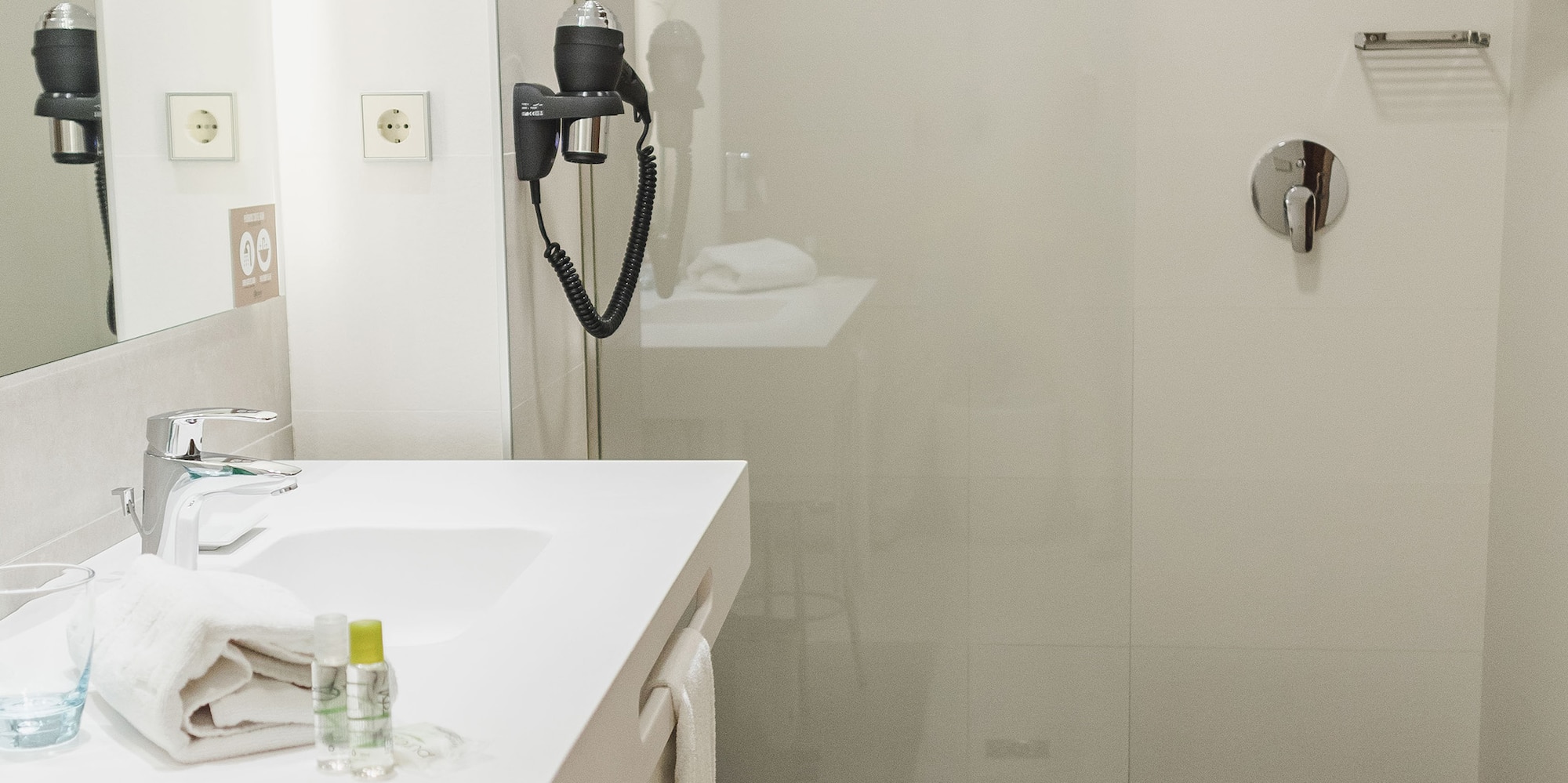 a bathroom with a shower and sink