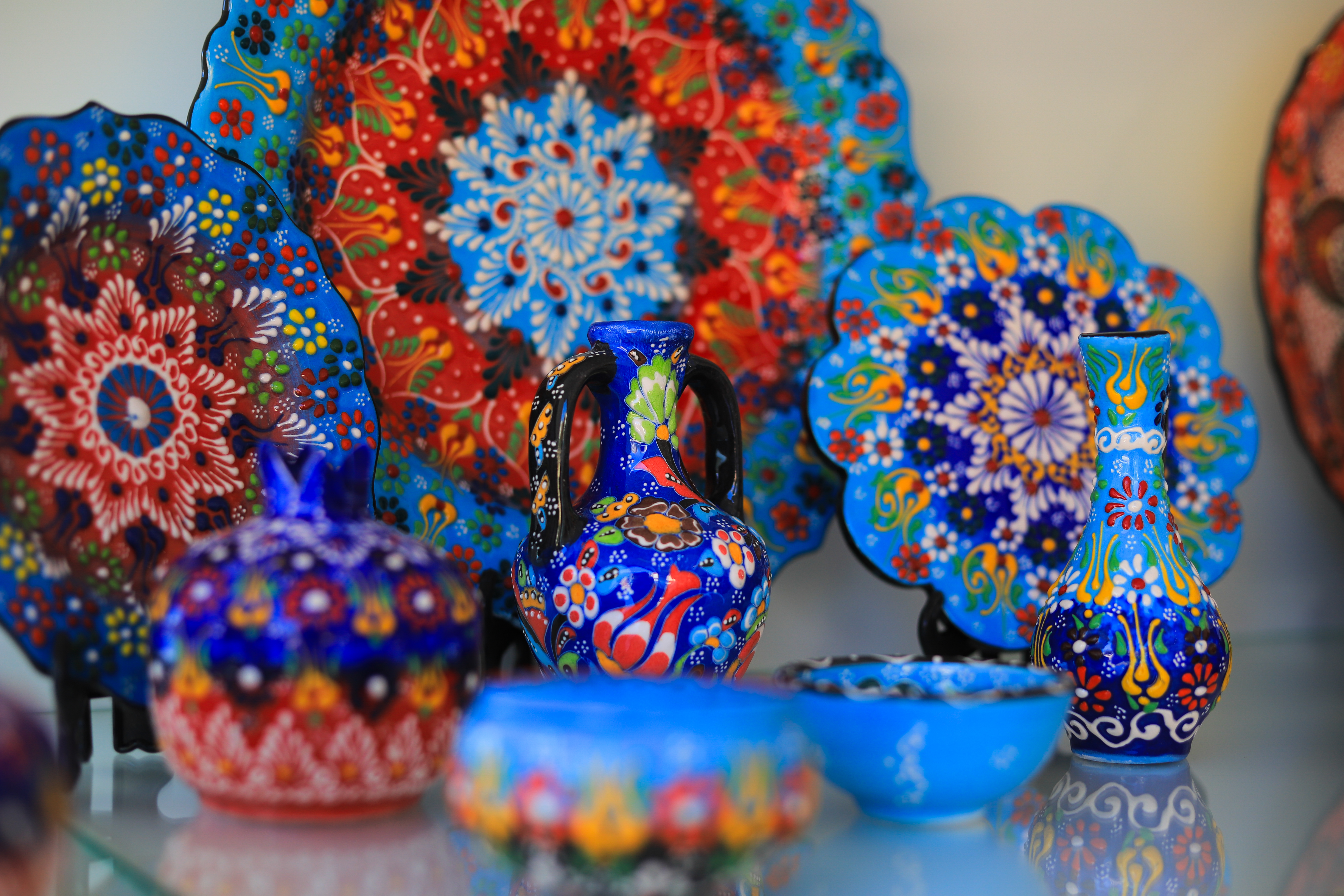 a collection of colorful pottery