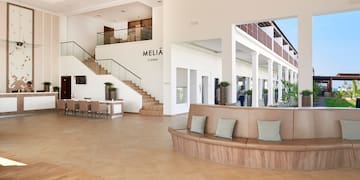 a large room with a large couch and stairs