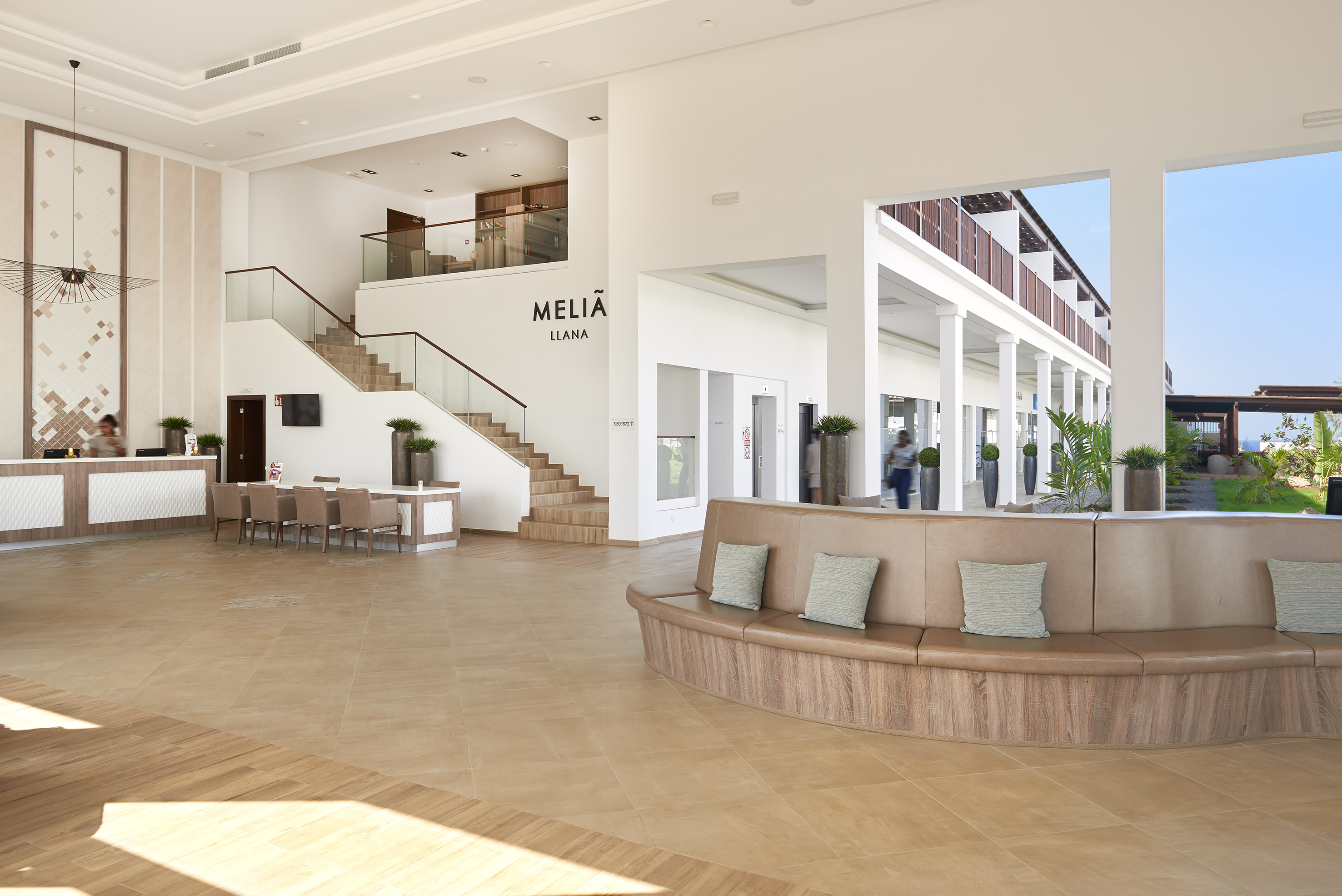 a large room with a large couch and stairs