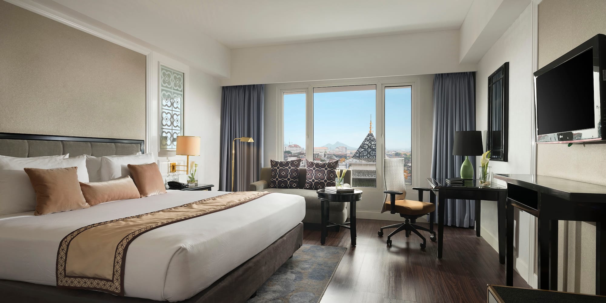 a bedroom with a large bed and a desk