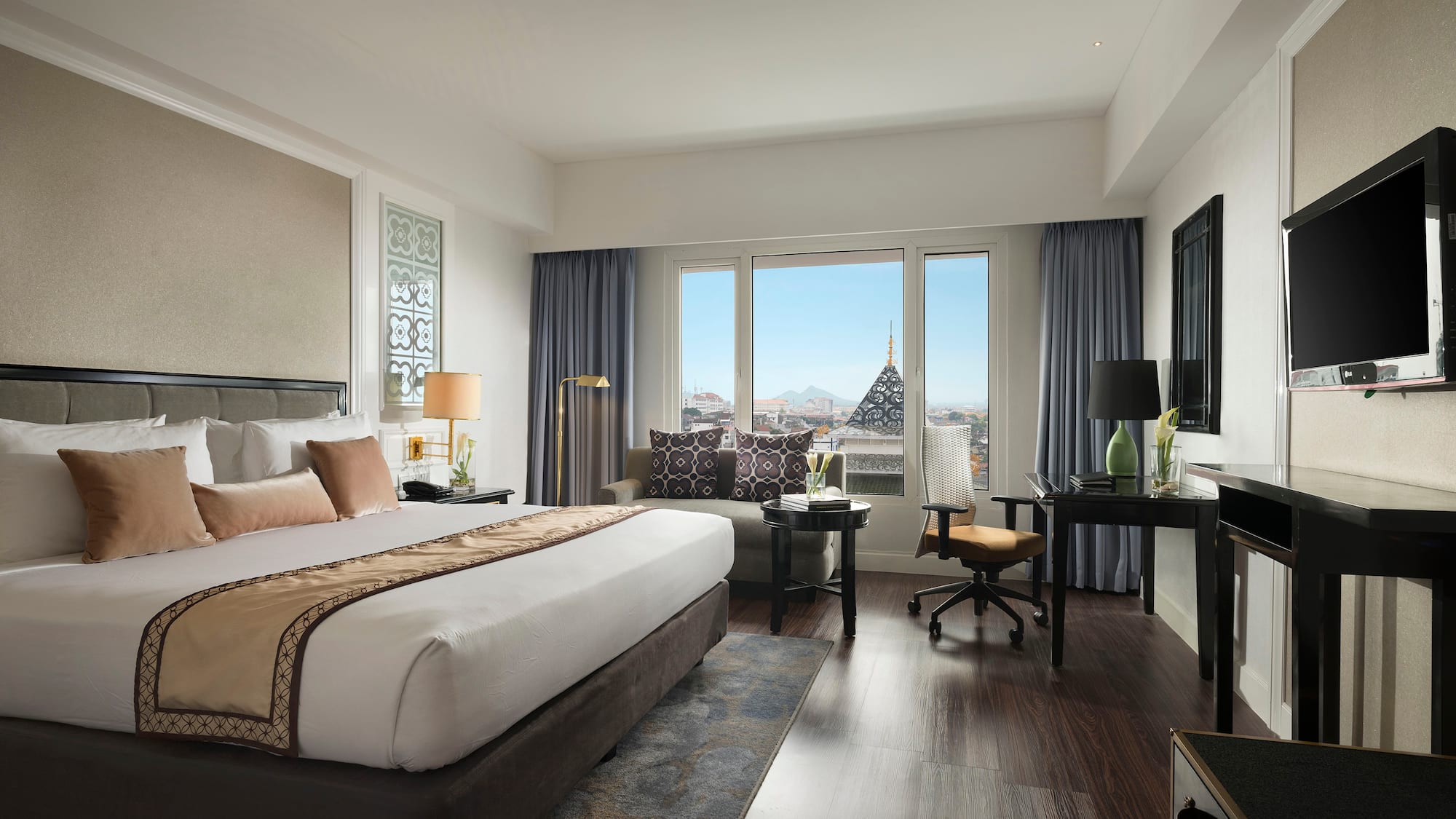 a bedroom with a large bed and a desk