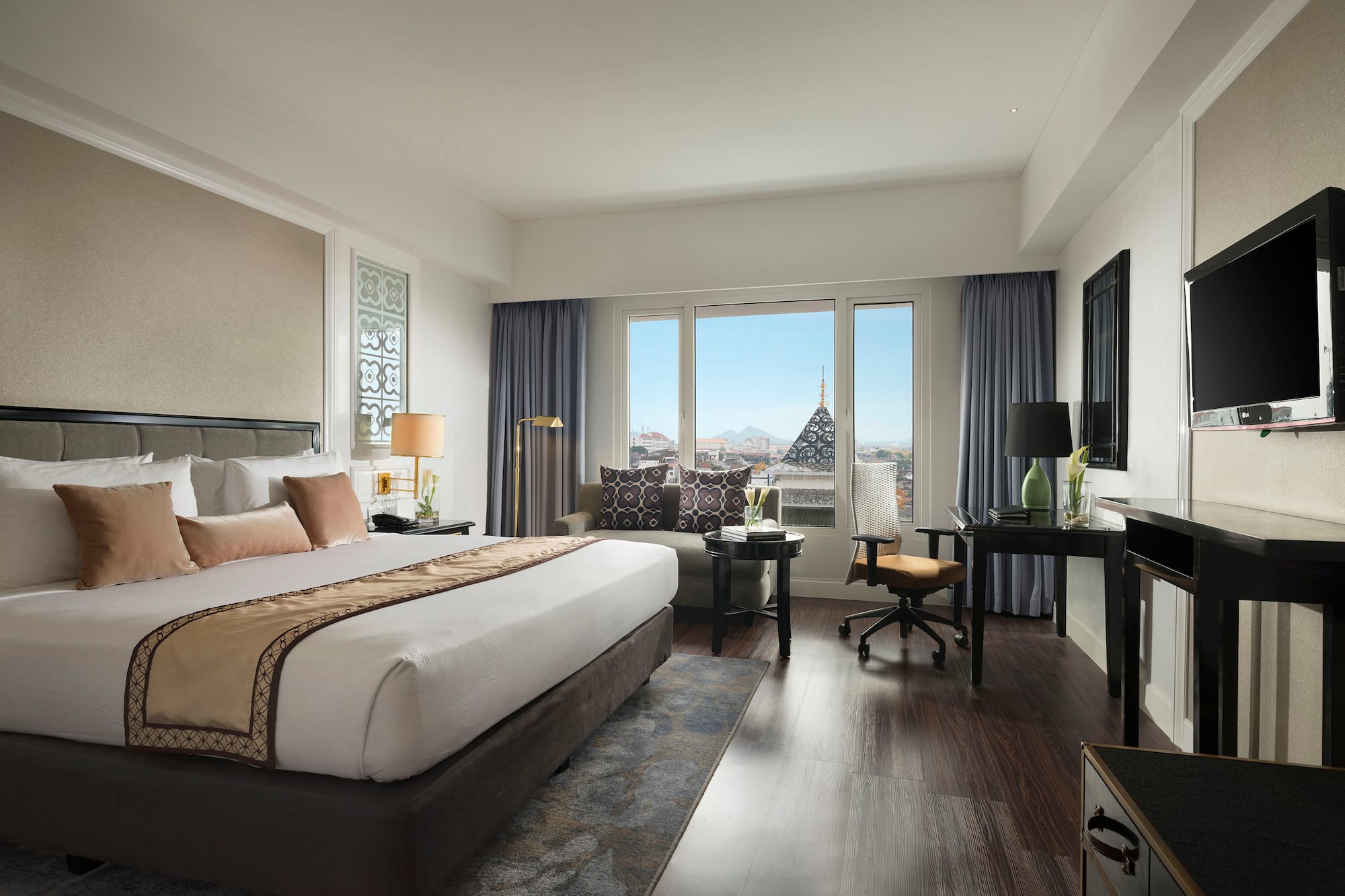 a bedroom with a large bed and a desk