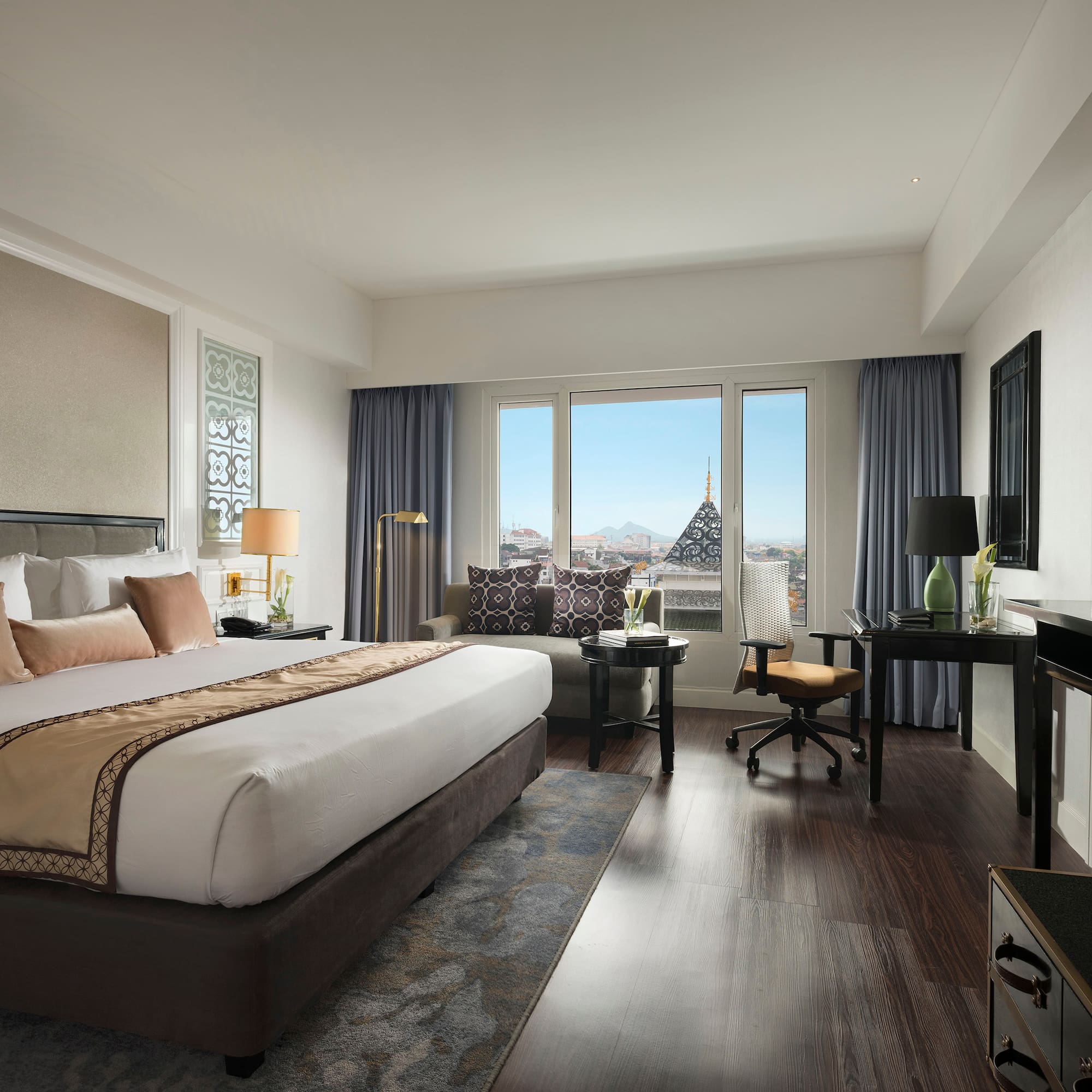 a bedroom with a large bed and a desk