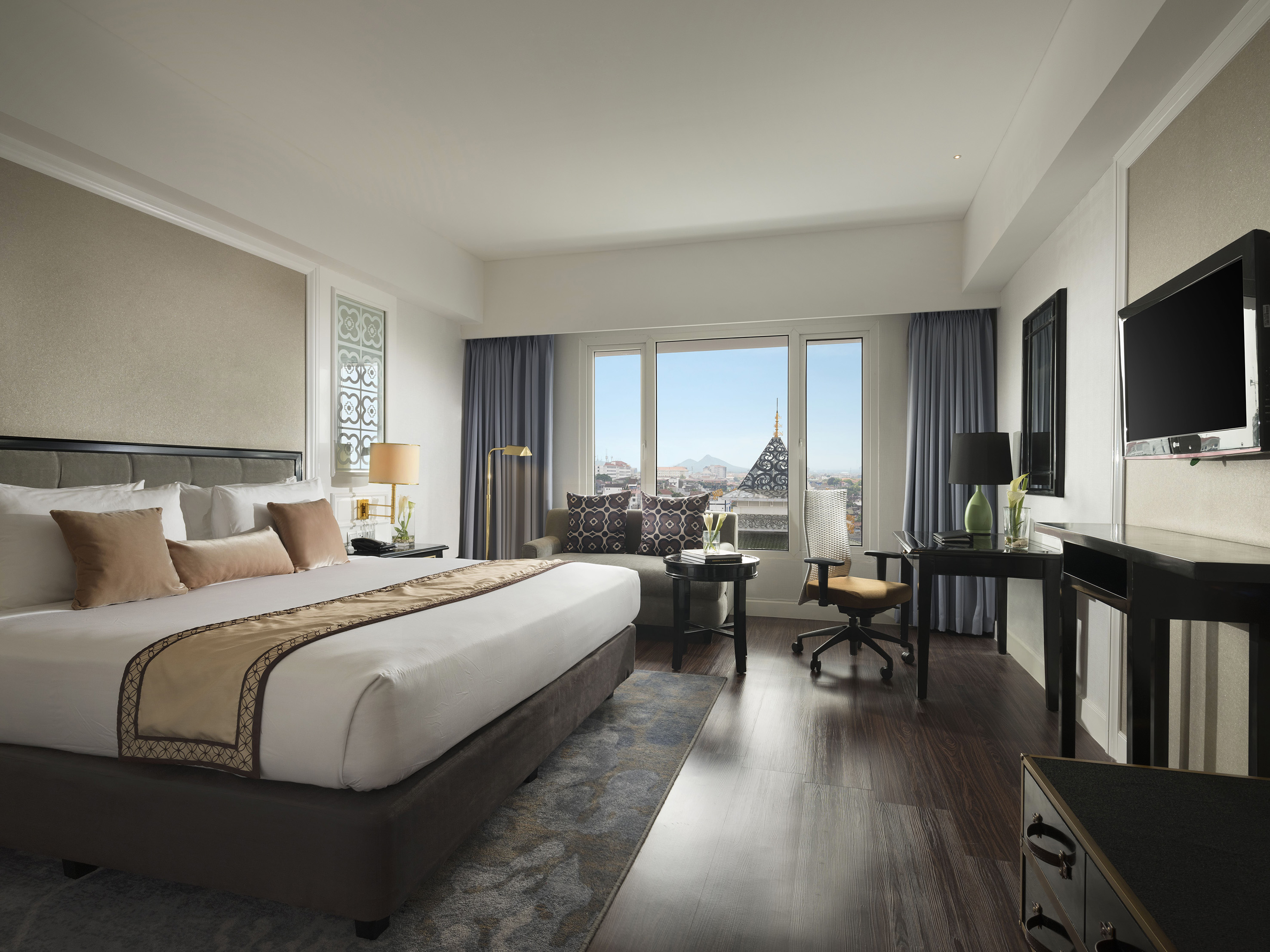 a bedroom with a large bed and a desk