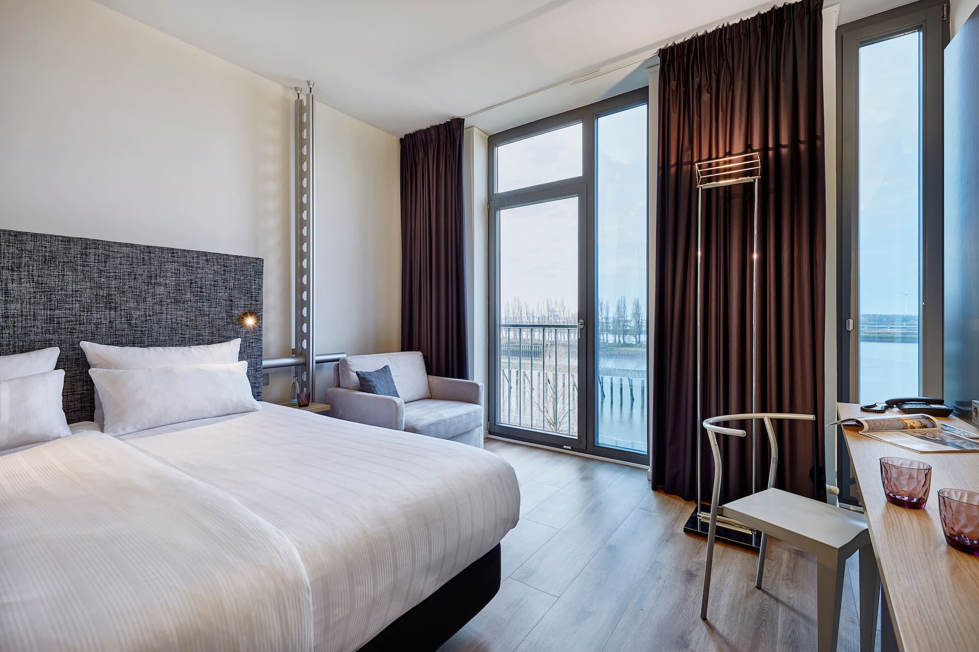 a room with a bed and a chair and a chair