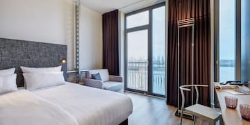 a room with a bed and a chair and a chair