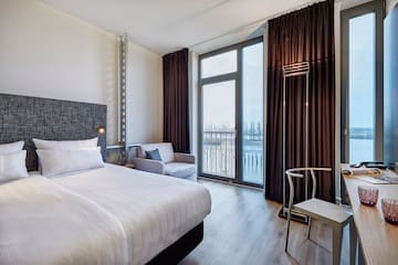 a room with a bed and a chair and a chair